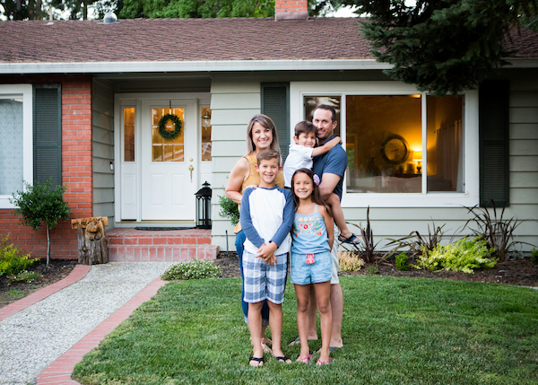 Agri City offers Comprehensive Insurance Products for Families. Image of family in front of their home.