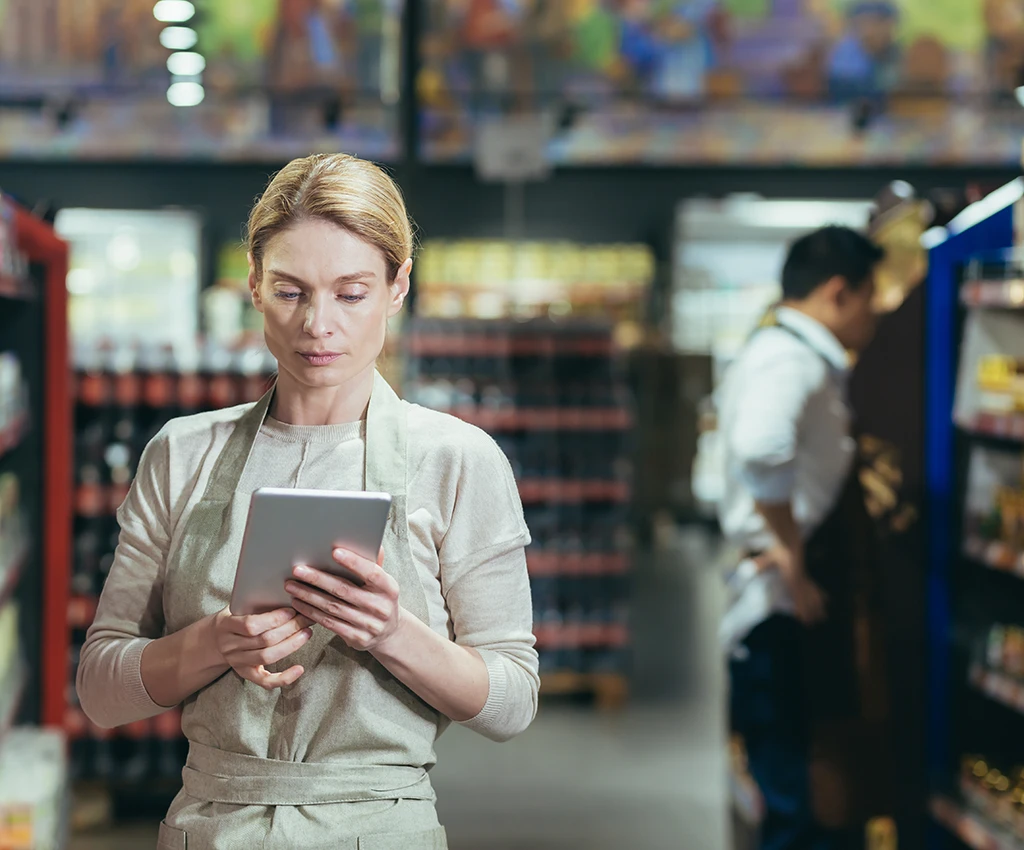 grocery store attendant checking inventory